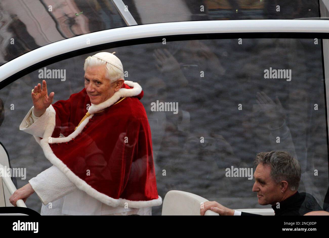 Pope Benedict XVI waves from his popemobile as he arrives for the ...