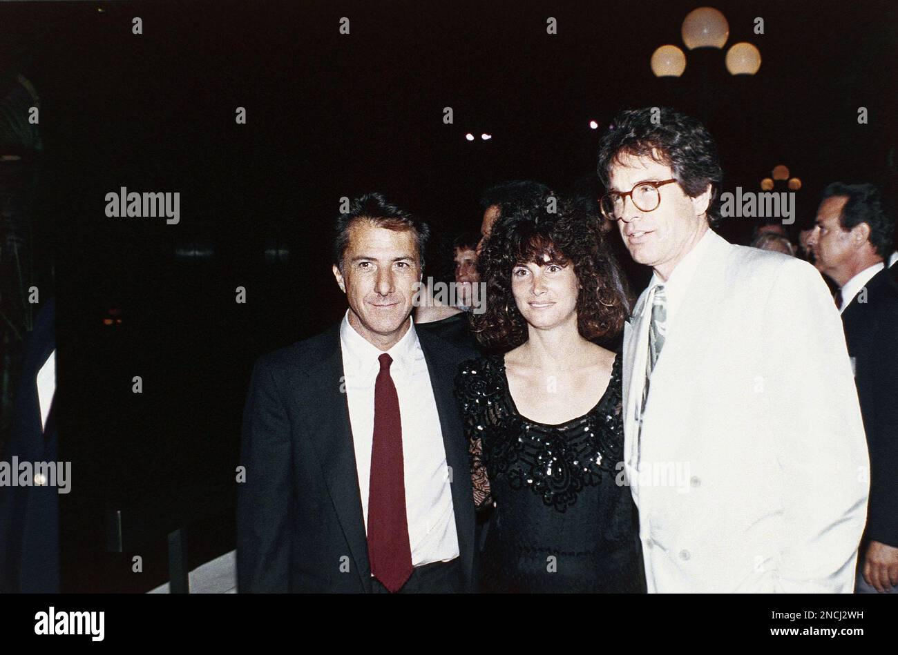 Dustin Hoffman and his wife Lisa pose for photographers with actor Warren Beatty as they leave