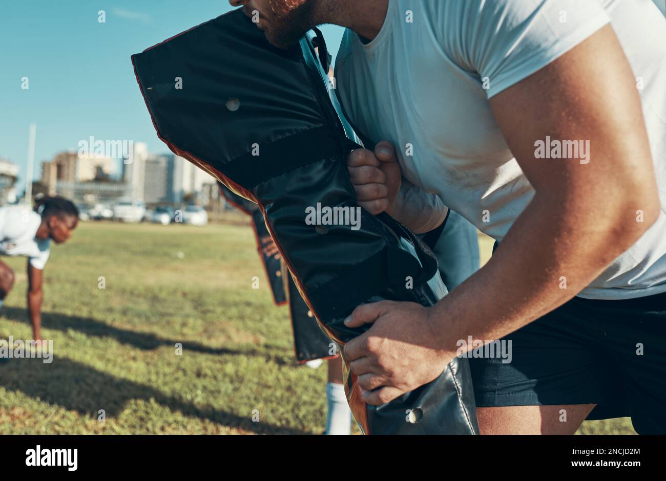 Toughen up guys. rugby players training with tackle bags on the field