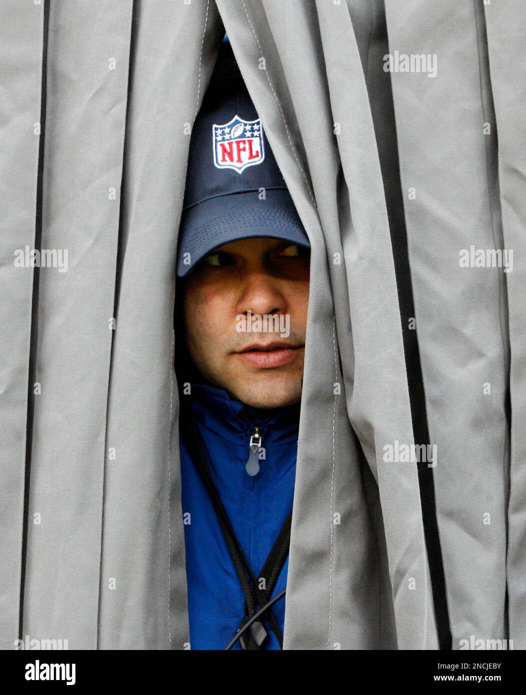 Joe Eckberg tries to stay warm in the instant replay booth on the field at  Lambeau Field before an NFL football game between the Green Bay Packers and  the San Francisco 49ers