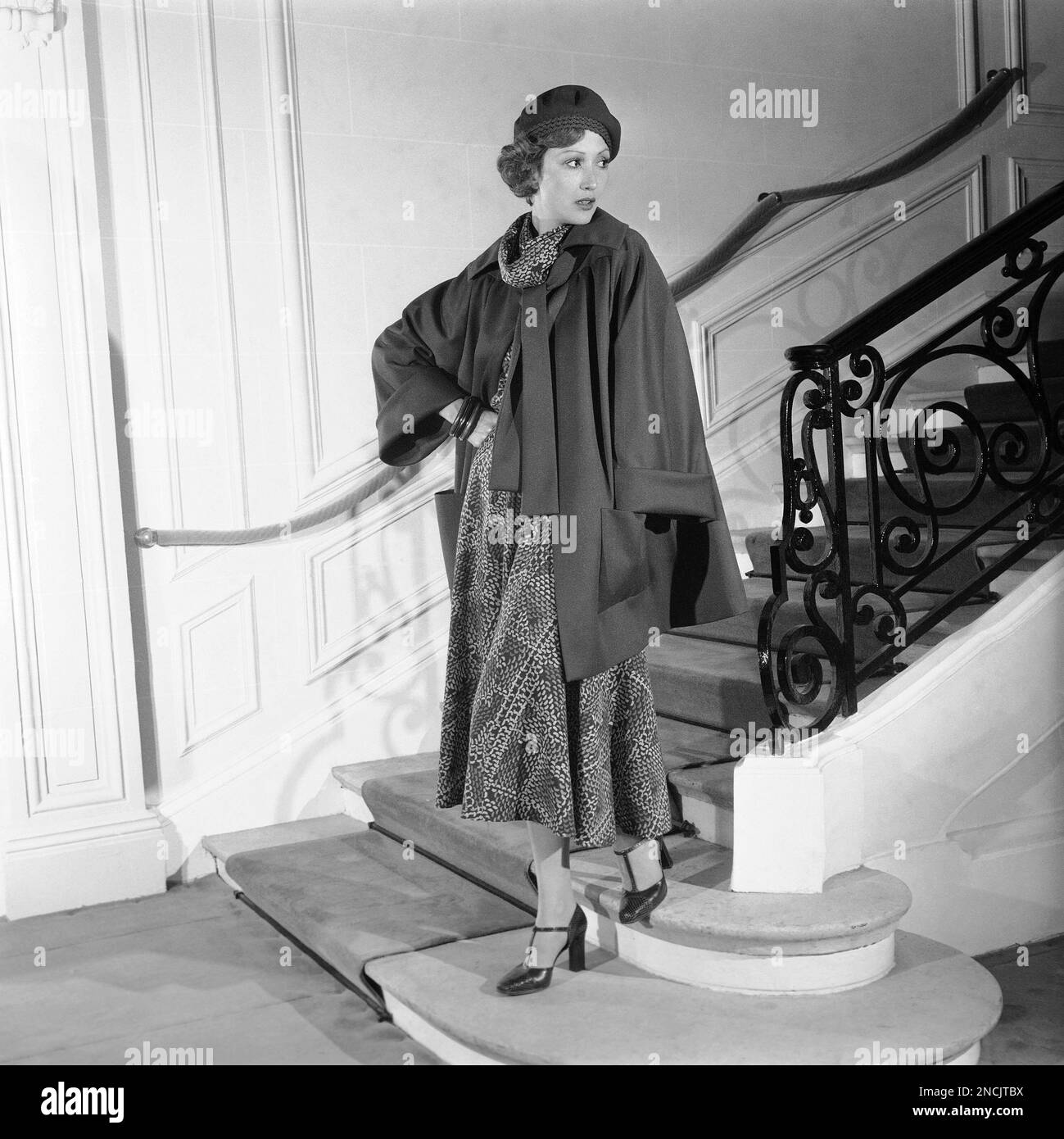 From the 1974-75 fall and winter collection of Paris' Christian Dior  fashion house, shown July 17, 1974, a model wears this beige, brown and red  printed wool veil dress worn under a