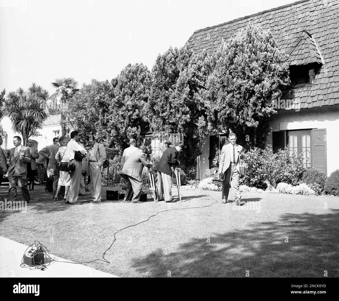 Newsmen gather on the front lawn of the Marilyn Monroe Joe DiMaggio
