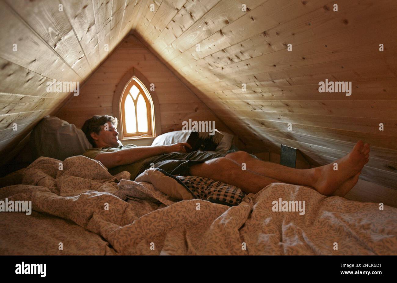 https://c8.alamy.com/comp/2NCK6D1/in-this-photo-taken-oct-14-2010-jay-shafer-owner-of-tumbleweed-tiny-houses-reads-a-book-in-the-loft-of-a-small-house-he-built-for-himself-in-graton-calif-in-a-country-where-most-people-want-to-live-large-schafer-helps-people-live-small-the-california-homebuilder-has-become-a-leader-in-a-small-but-growing-corner-of-the-american-housing-market-the-tiny-house-shafer-who-lived-in-a-89-square-foot-house-with-his-wife-before-his-son-was-born-last-year-builds-houses-that-are-smaller-than-most-peoples-living-rooms-ap-photoben-margot-2NCK6D1.jpg