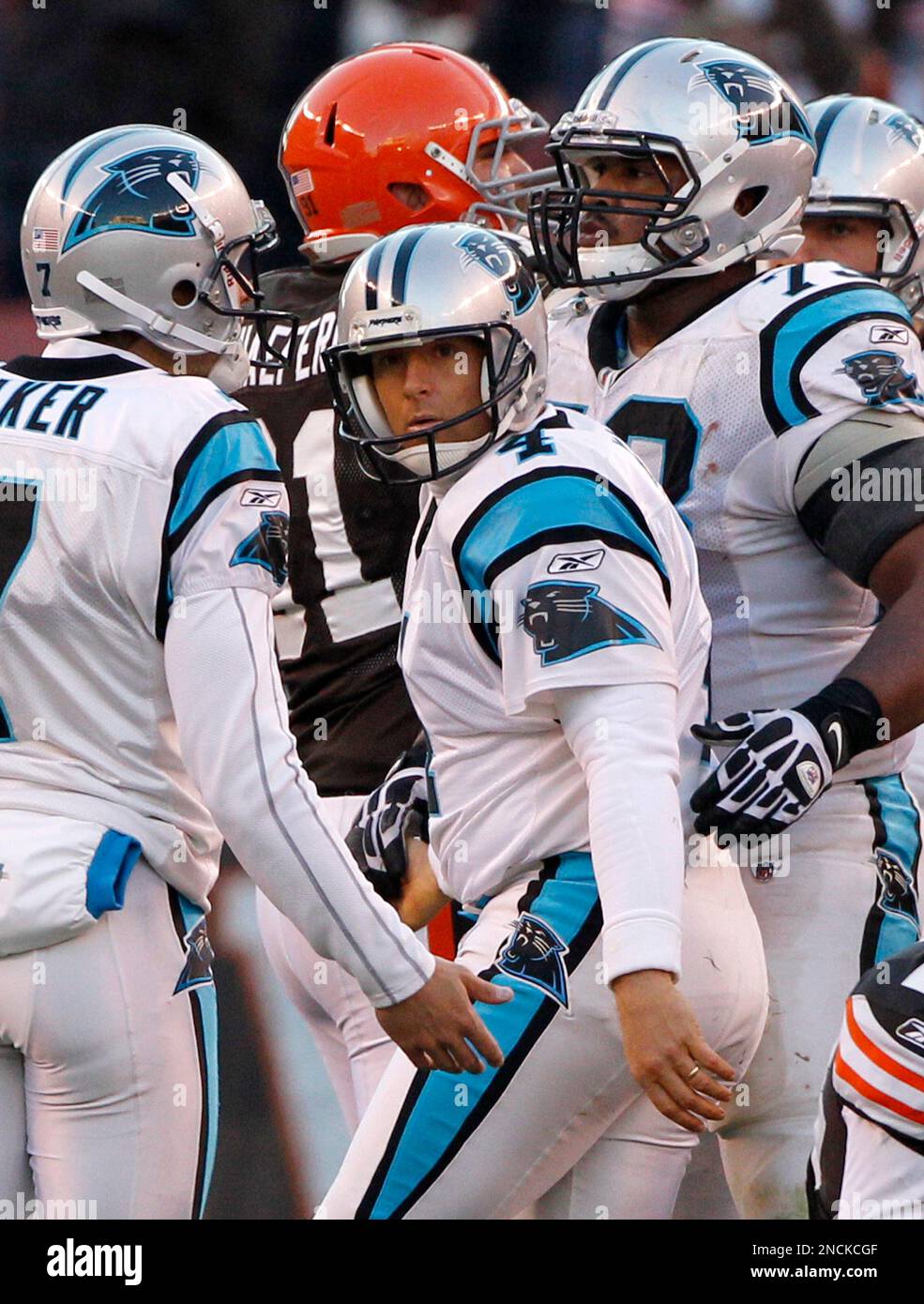 Carolina Panthers place kicker John Kasay, center, is consloed by teammates  punter Jason Baker, left, and guard Mackenzy Bernadeau (73), right, ater  missing a field goal that would have won the game