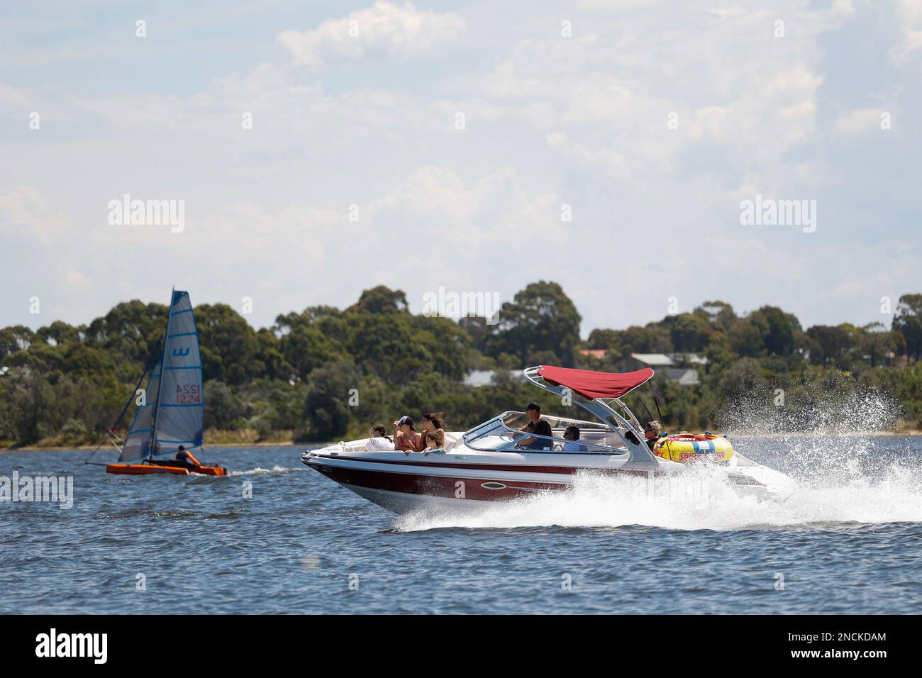 Family in a fast moving motor boat ,Gippsland Lakes, Paynesville, Victoria, Australia. Stock Photo