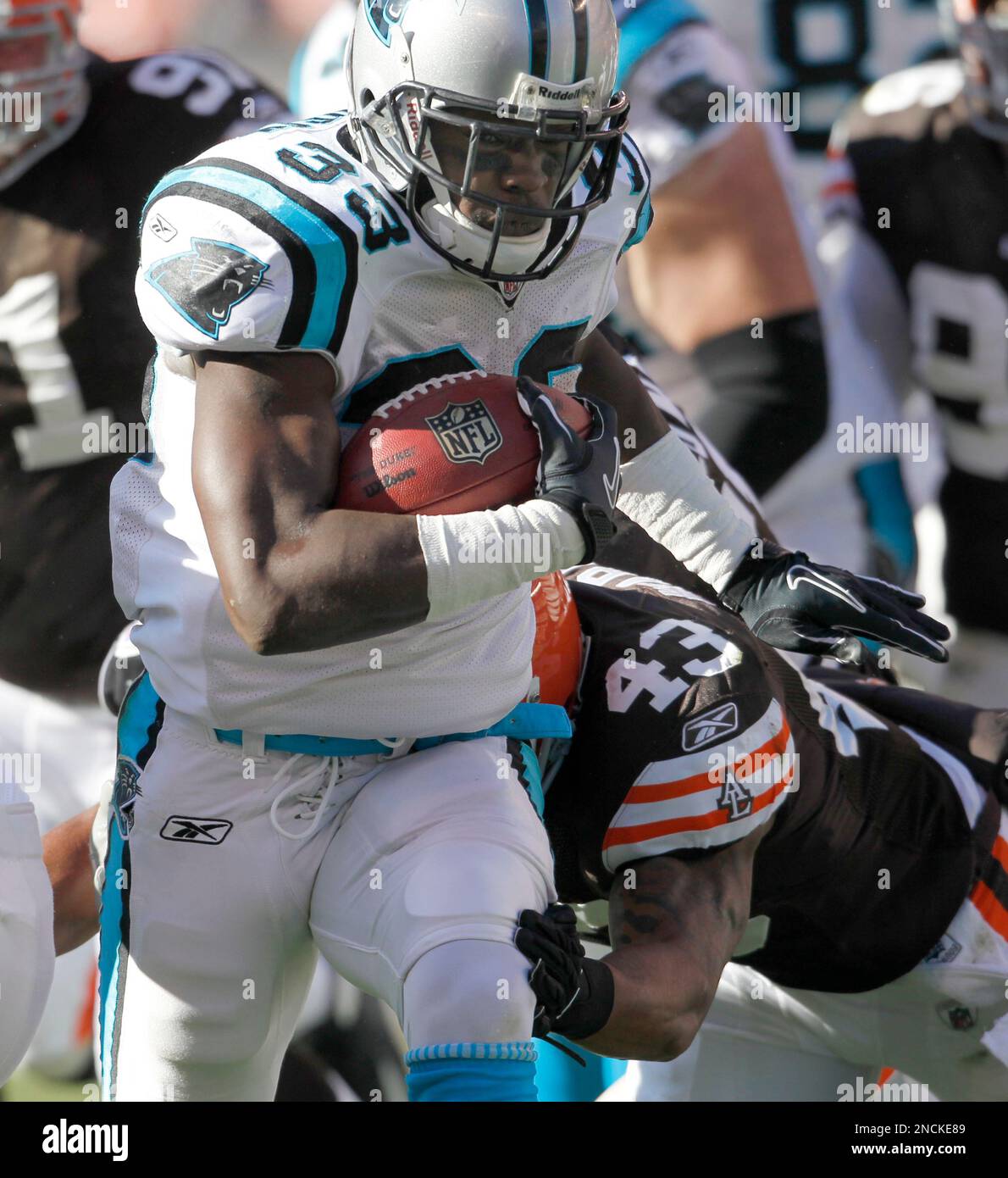 Carolina Panthers running back Mike Goodson (33) pushes through Cleveland Browns safety T.J. Ward (43) for a touchdown during first-quarter action in an NFL football game on Sunday, Nov. 28, 2010, in Cleveland. (AP Photo/Ron Schwane) Stock Photo