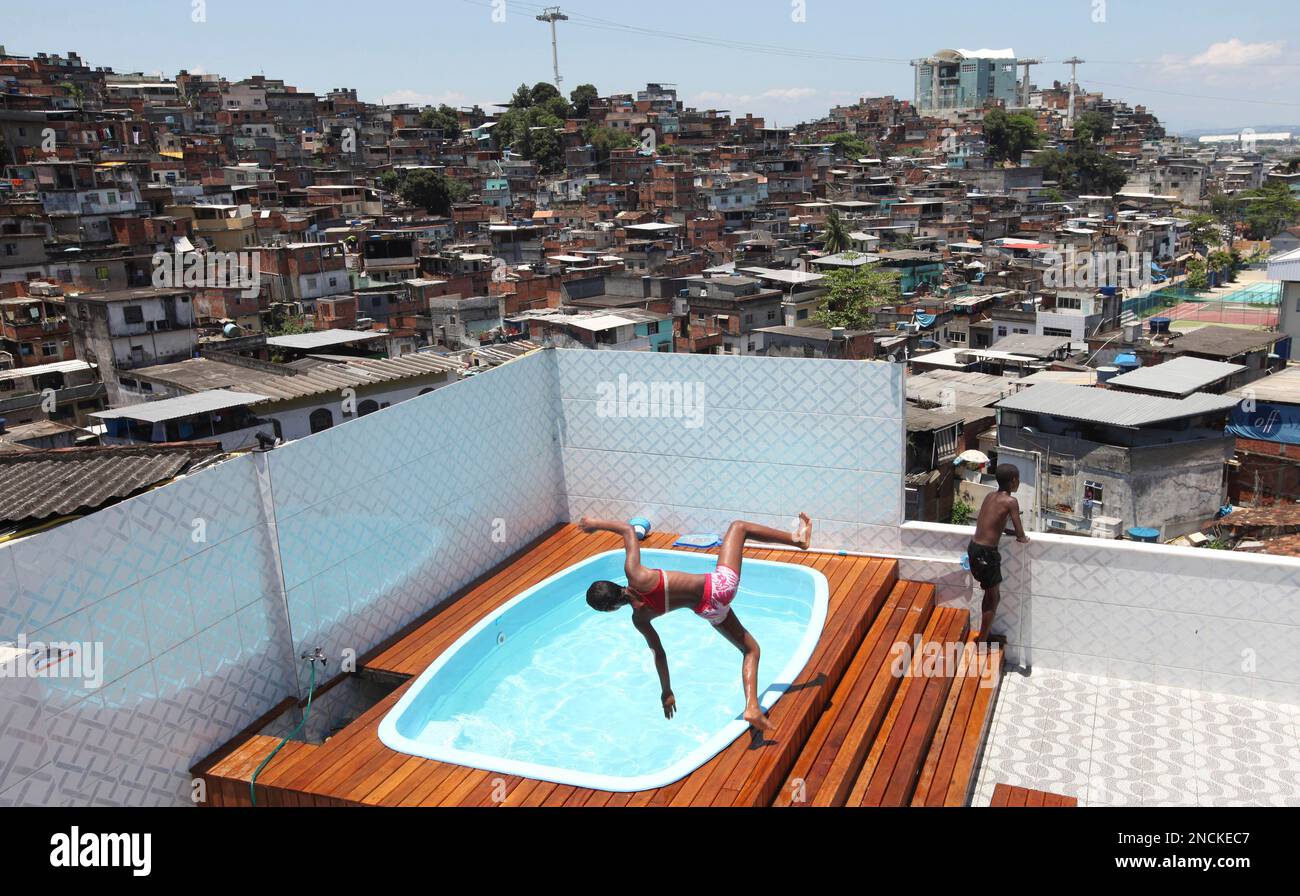 Children play in a pool at the house of an alleged drug trafficker at ...