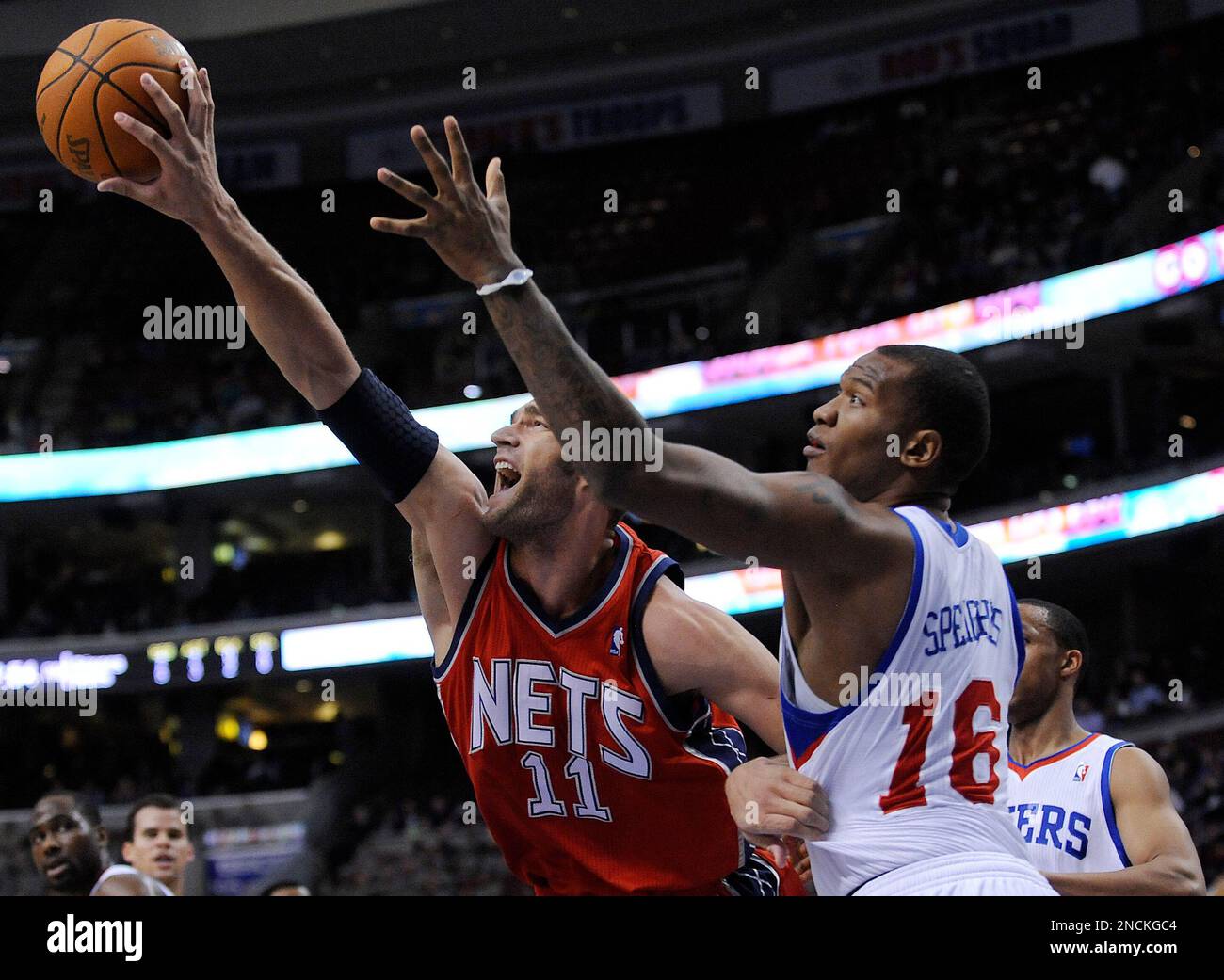 New Jersey Nets' Brook Lopez (11) reaches for a rebound over Philadelphia  76ers' Marreese Speights during the first half of an NBA basketball game in  Philadelphia, Saturday, Nov. 27, 2010, in Philadelphia. (