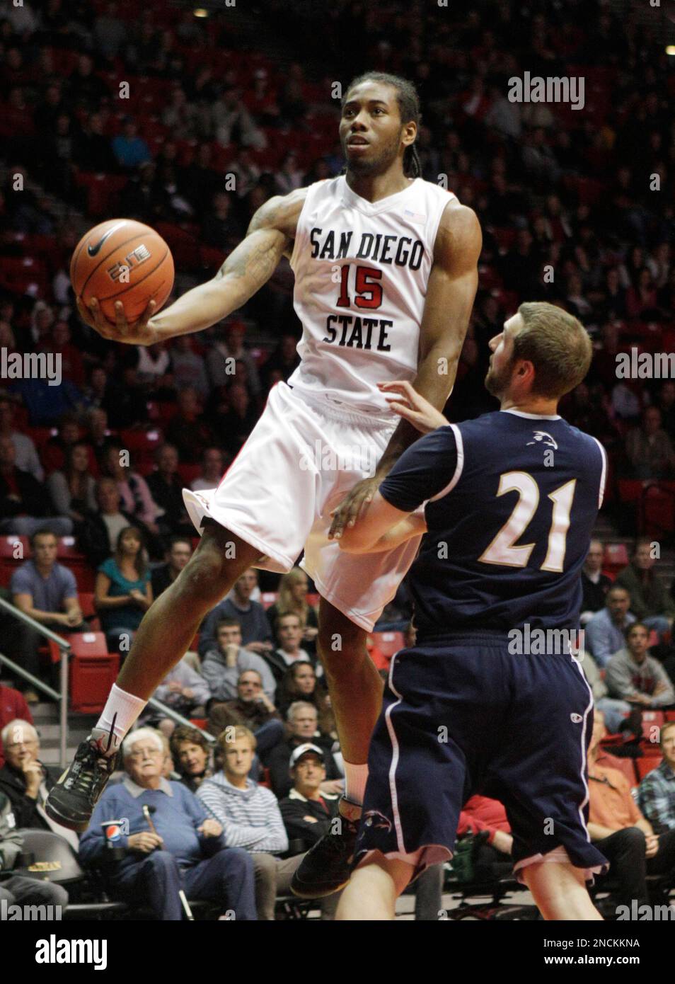 San Diego State's Kawhi Leonard (15) sails over San Diego Christian's Tyler Mutton while going to the rim during the first half of a NCAA college basketball game, Friday, Nov. 26, 2010, in San Diego. (AP Photo/Lenny Ignelzi) Stock Photo