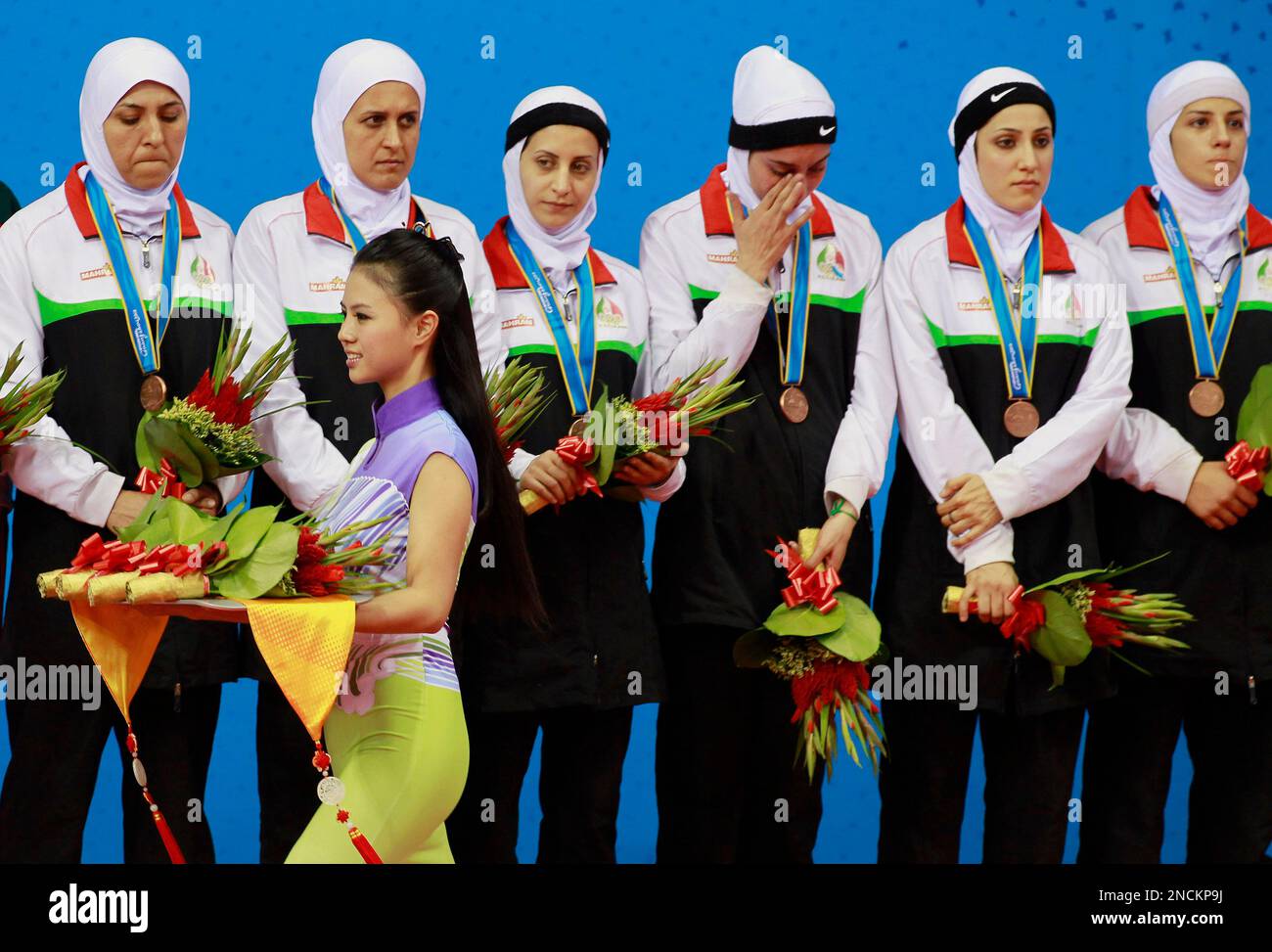Members of the bronze medalwinning Iranian kabaddi team look on as a