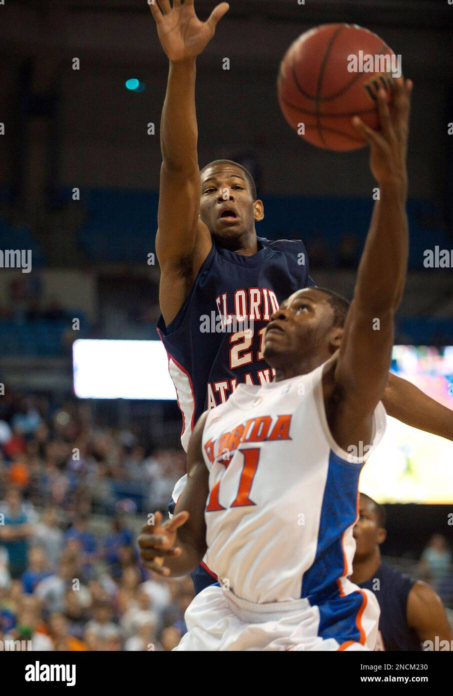 Florida guard Erving Walker (11) tries to shoot as Florida Atlantic's