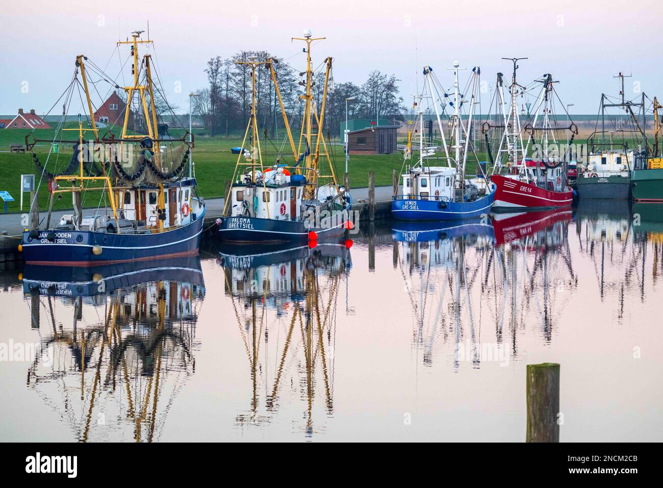 Greetsiel, Germany. 14th Feb, 2023. Shrimp cutters lie in the harbor. The new North Sea Tourism Agency (Tano) wants to start building a uniform brand for the North Sea coast from the Ems to the Elbe this spring. (to dpa 'New tourism agency wants to strengthen the sense of unity on the coast') Credit: Sina Schuldt/dpa/Alamy Live News Stock Photo