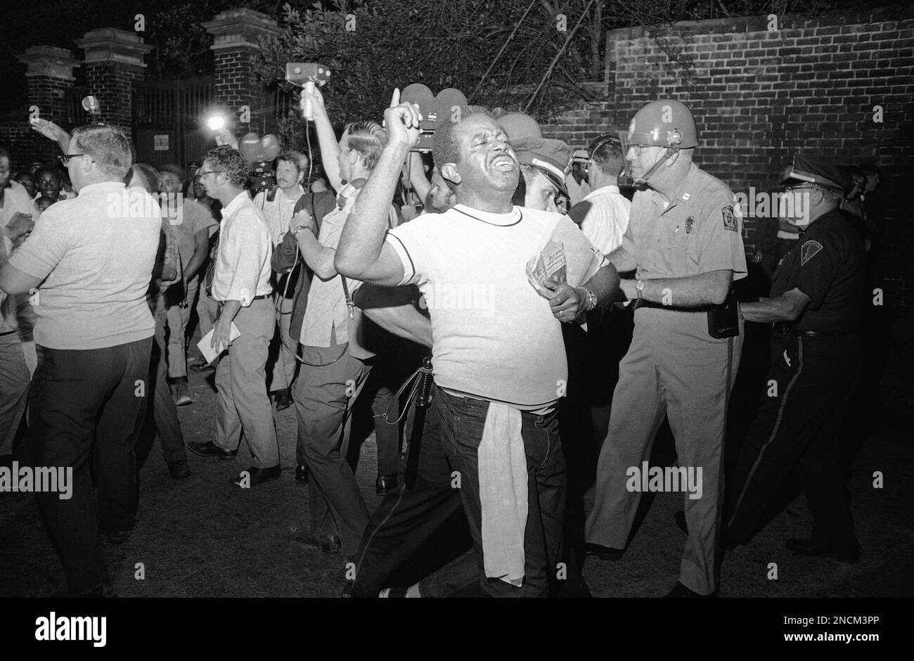 Rev. Ralph David Abernathy, head of the SCLC is led away by a police
