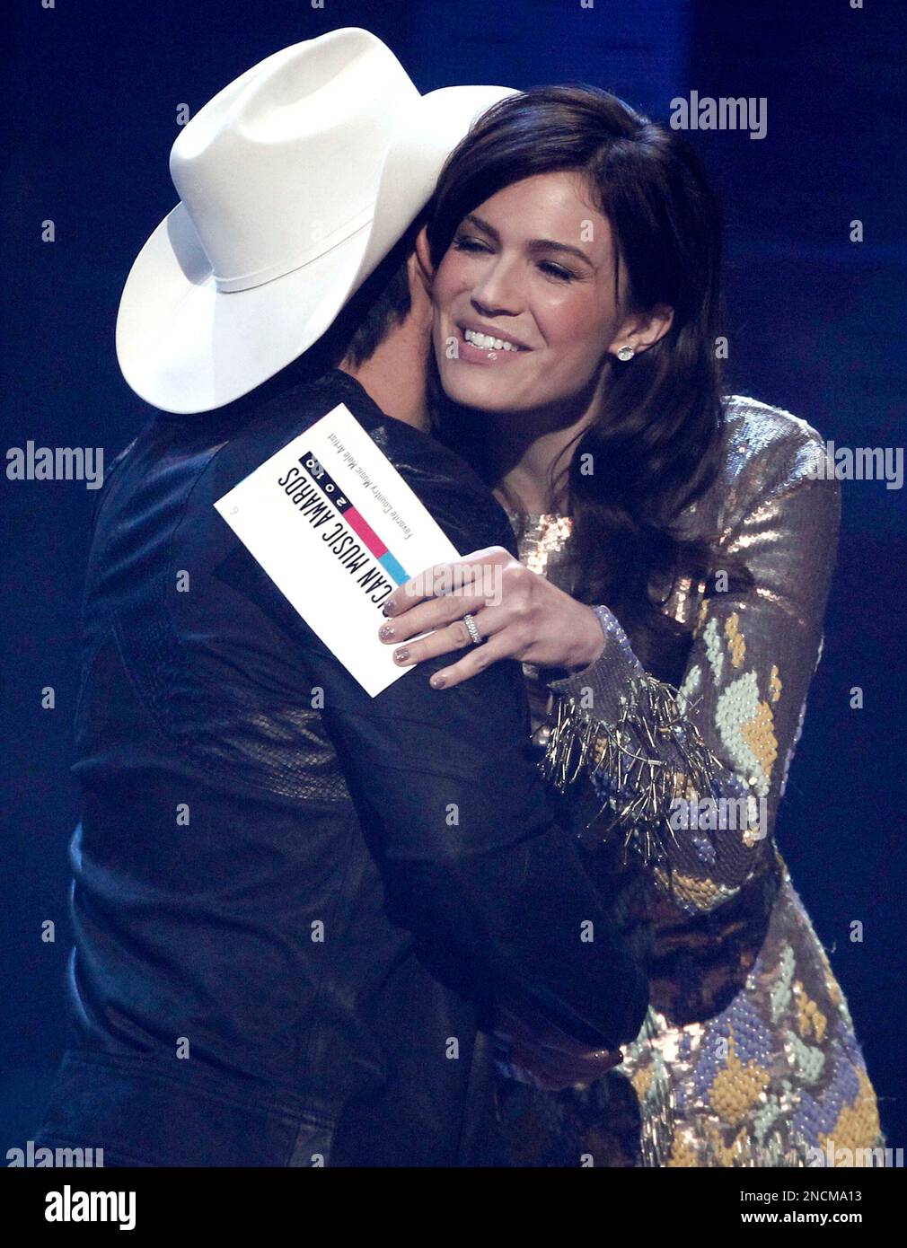 Mandy Moore, right, presents Brad Paisley with the award for country favorite male artist at the 38th Annual American Music Awards on Sunday, Nov. 21, 2010 in Los Angeles. (AP PhotoMatt Sayles