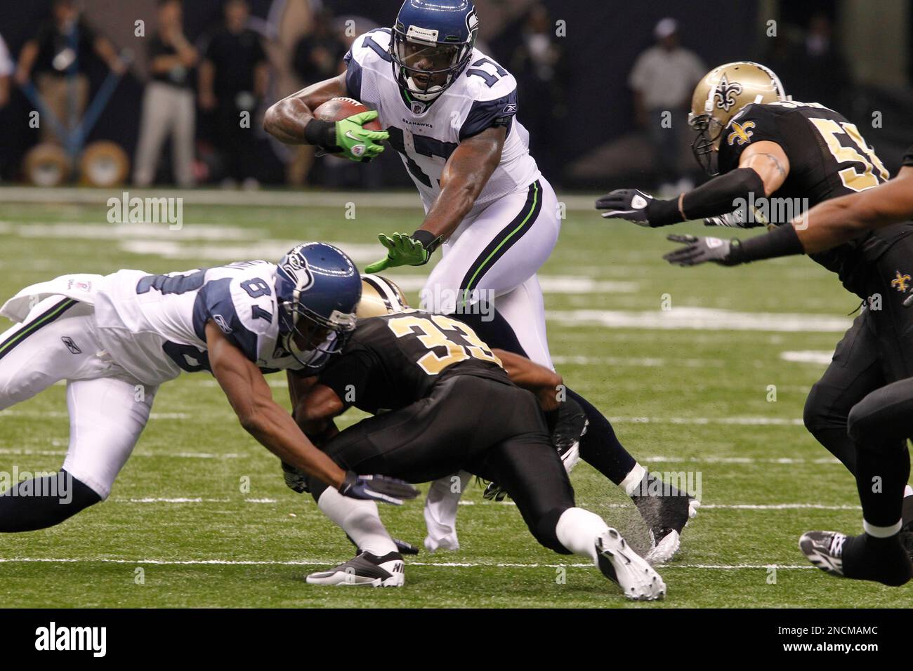 New Orleans Saints linebacker Anthony Waters hols up his jersey