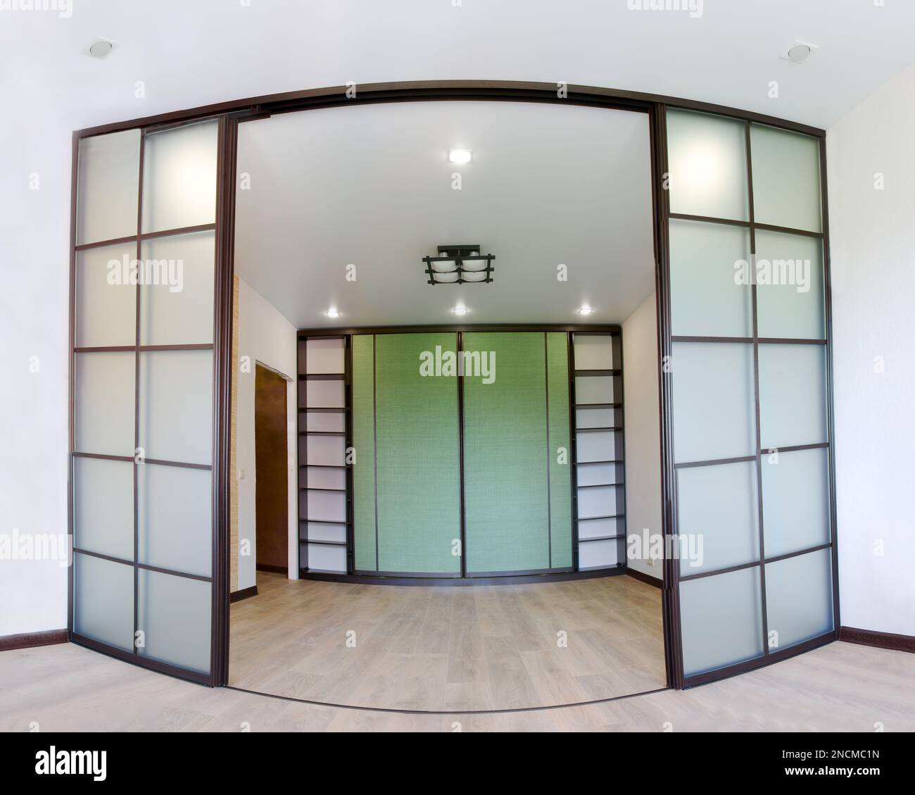Wide angle photo of the repair of interior of new living room with sliding doors coupe in Japanese style Shoji with a wardrobe. Modern Asian design Stock Photo