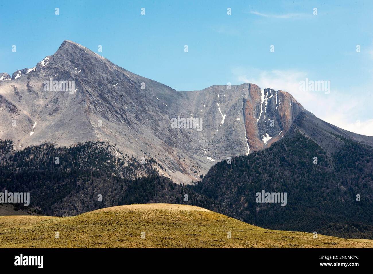 Mount Borah from the North.  The vertical orange (calcareous siltstone)  and black (dolomite) bands to the right of the peak make up the Jefferson For Stock Photo
