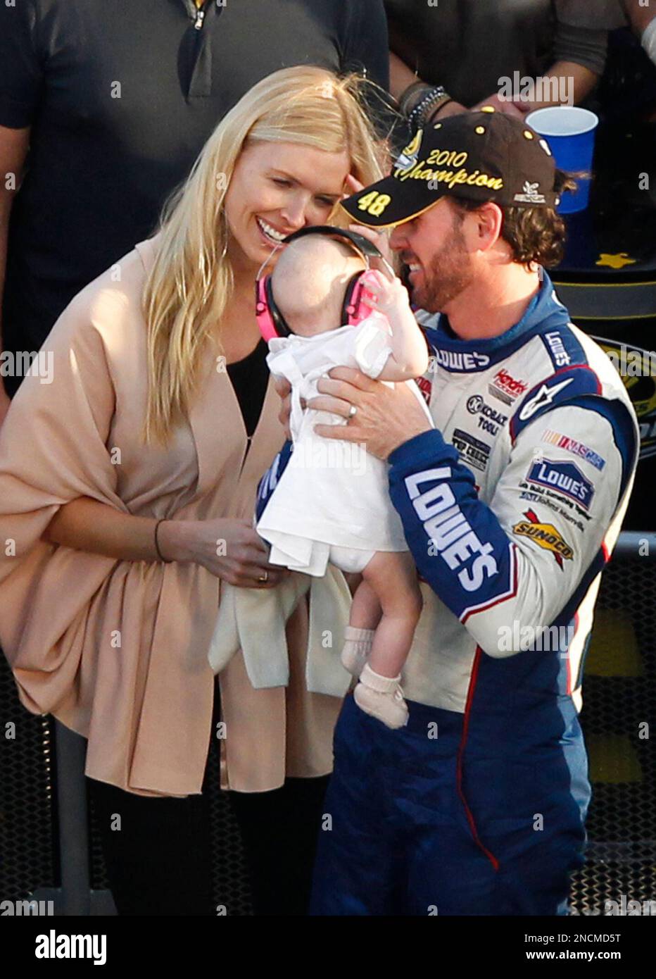 NASCAR driver Jimmie Johnson, right, holds his daughter Genevieve Marie(02)