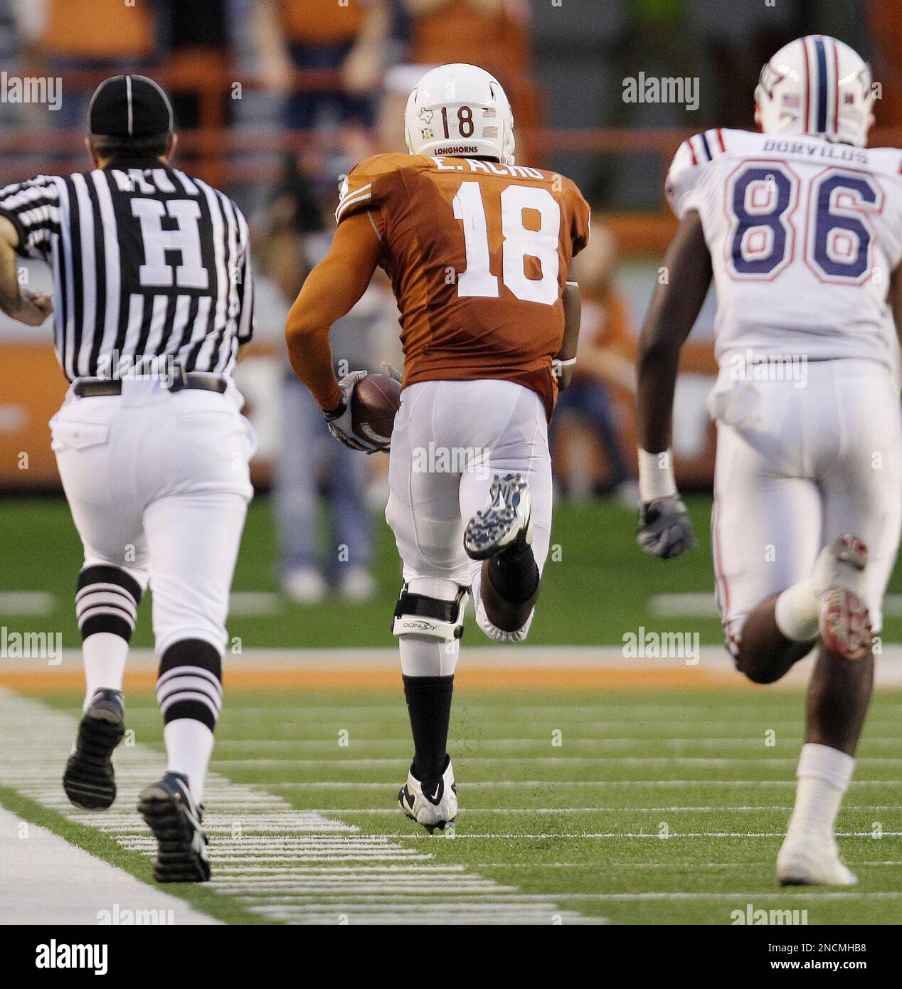 Texas' Emmanuel Acho (18) makes a 57-yard interception return for a score  as Florida Atlantic's Nexon Dorvilus (86) persues during the fourth quarter  of an NCAA college football game, Saturday, Nov. 20,