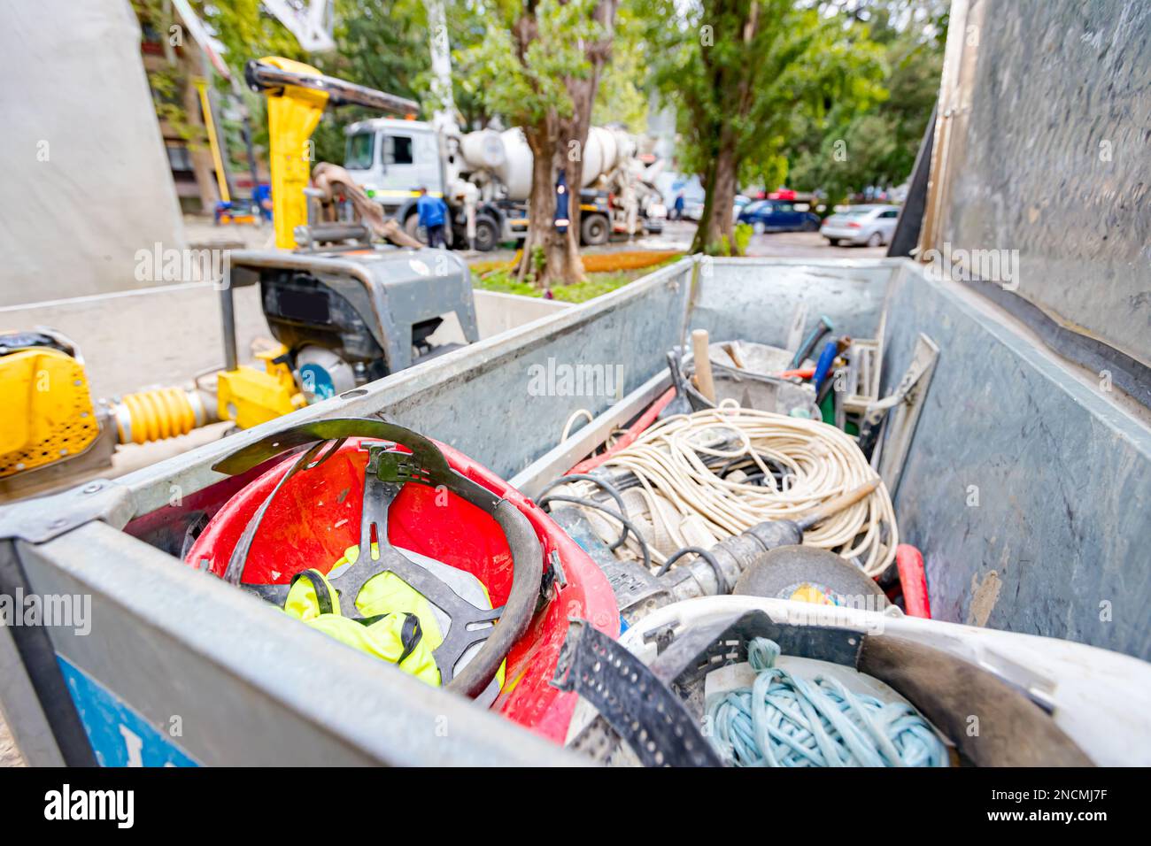 Steel crate, container, toolbox overfull of many different tools were placed in the truck trailer on the construction site. Stock Photo