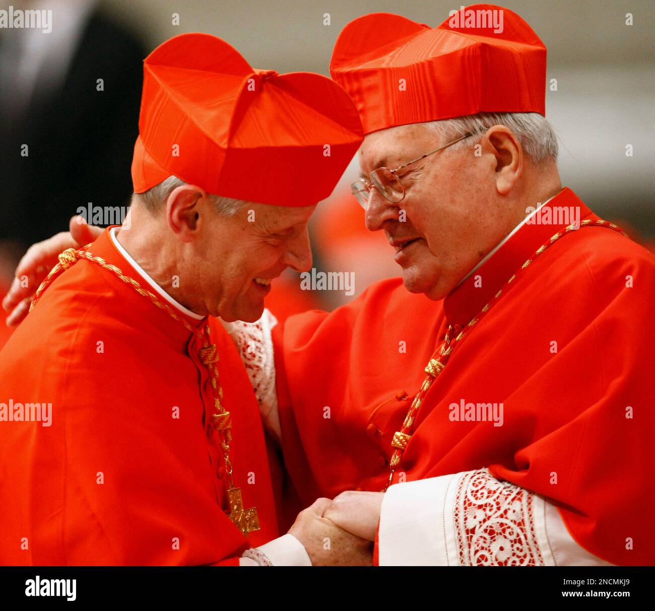 Newly-appointed US Cardinal Donald W. Wuerl, left, is congratulated by ...