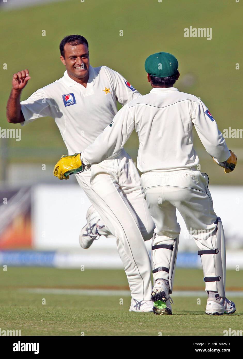 Pakistan's Tanveer Ahmed, left, celebrates with teammate Adnan