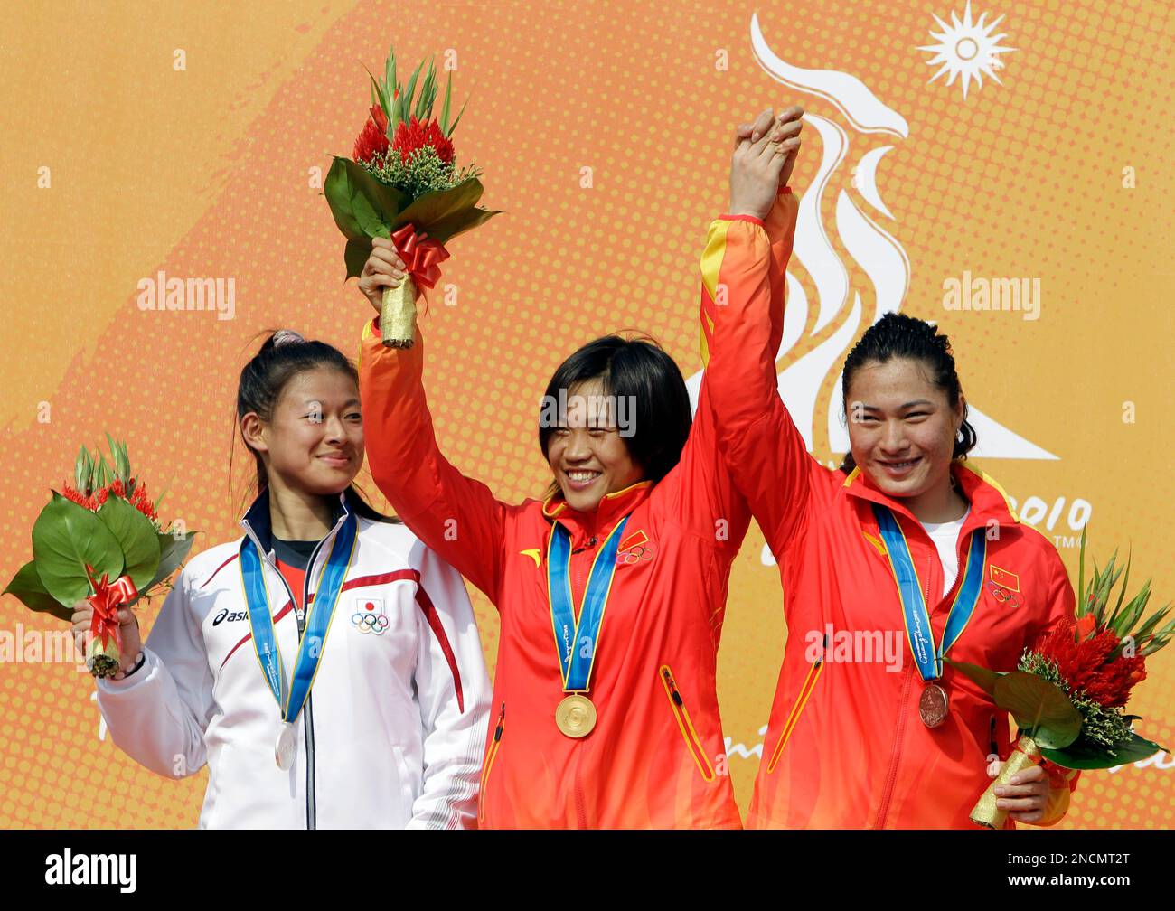 China's Ma Liyun, center, celebrates her BMX gold medal with compatriot ...