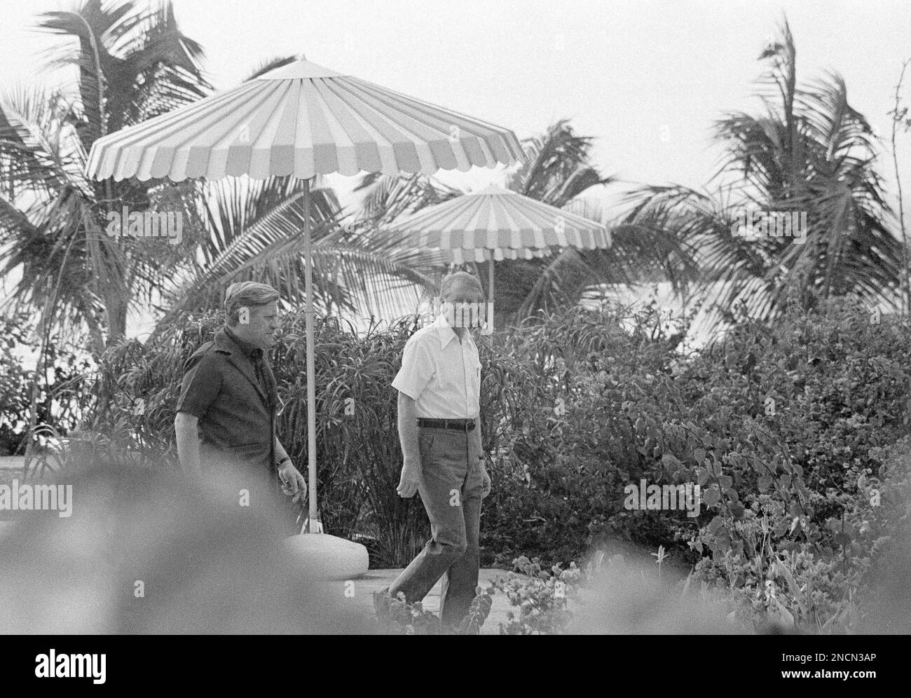 President Jimmy Carter, right, and West German Chancellor Helmut Schmidt walk down the beach
