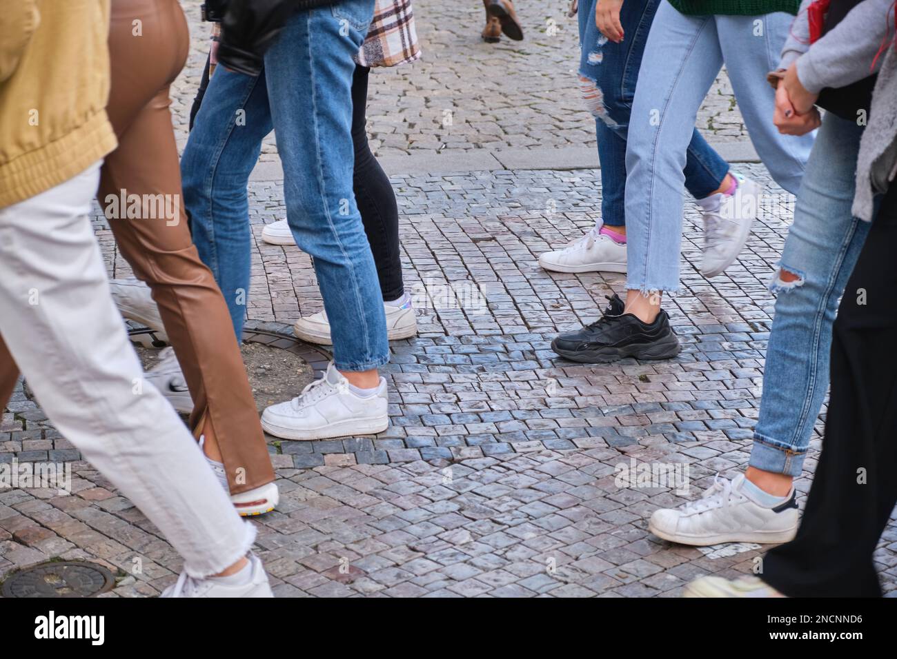 Low Section Of People pedestrians Walking On pavement Sidewalk old city center  Stock Photo
