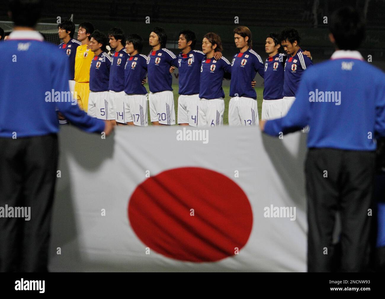 The Japanese team line up for their national anthem prior to the start of  their match against Kyrgyzstan at the 16th Asian Games in Guangzhou, China,  Saturday, Nov. 13, 2010. (AP Photo/Gurinder