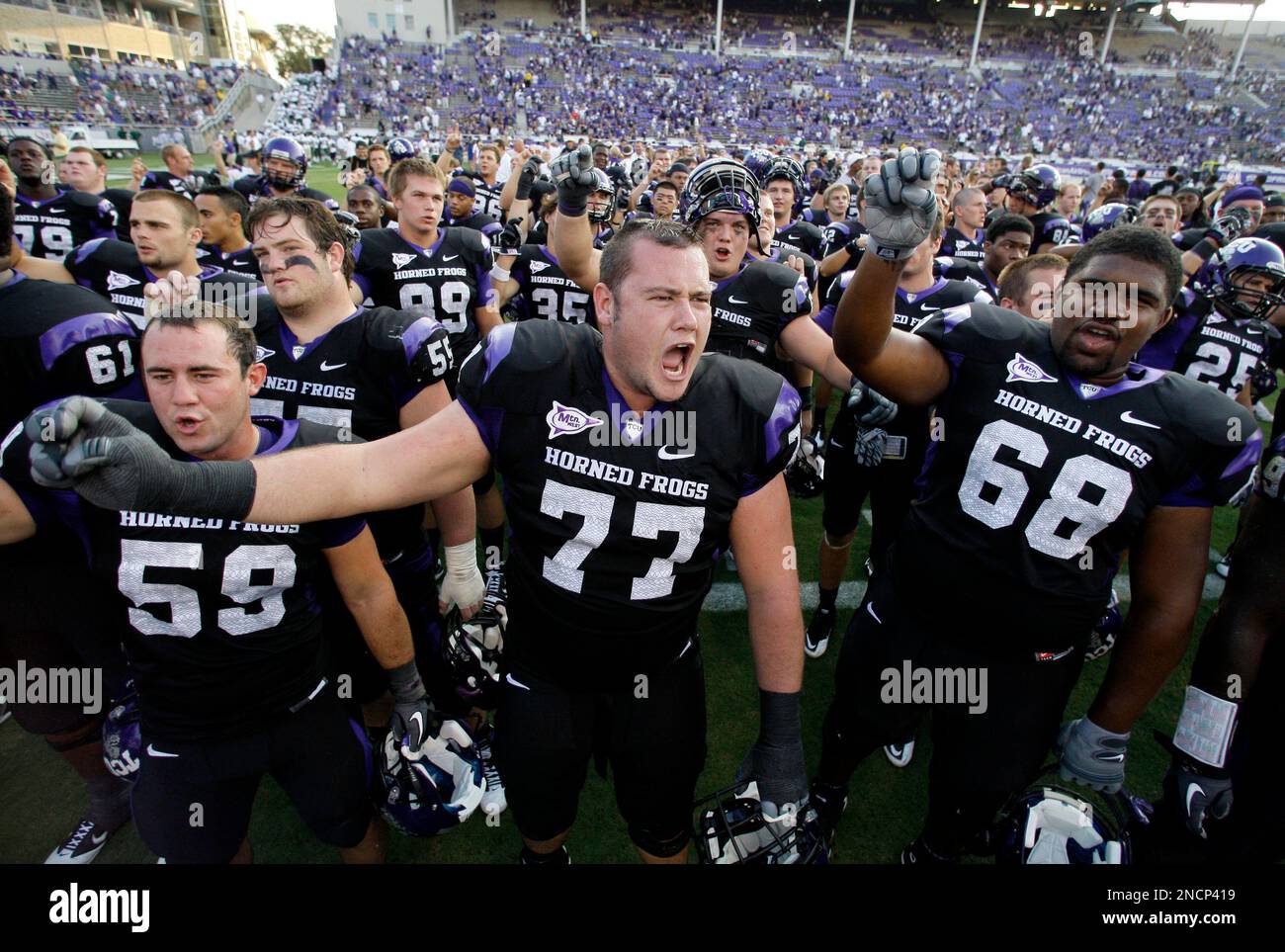 FILE - In this Sept. 18, 2010, file photo TCU's Logan Sligar (59), Spencer Thompson (77) and Trevius Jones (68) lead their teammates in song along with the student body in the stands following an NCAA college football game against Baylor. After 80 years, TCU's campus stadium is set for a major modernizing renovation. (AP Photo/Tony Gutierrez, file) Stock Photo