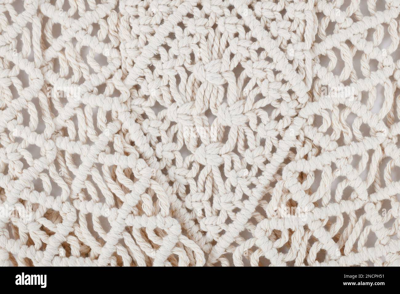 Close up of Macramé wall hanging pattern, a form of textile produced using knotting techniques Stock Photo