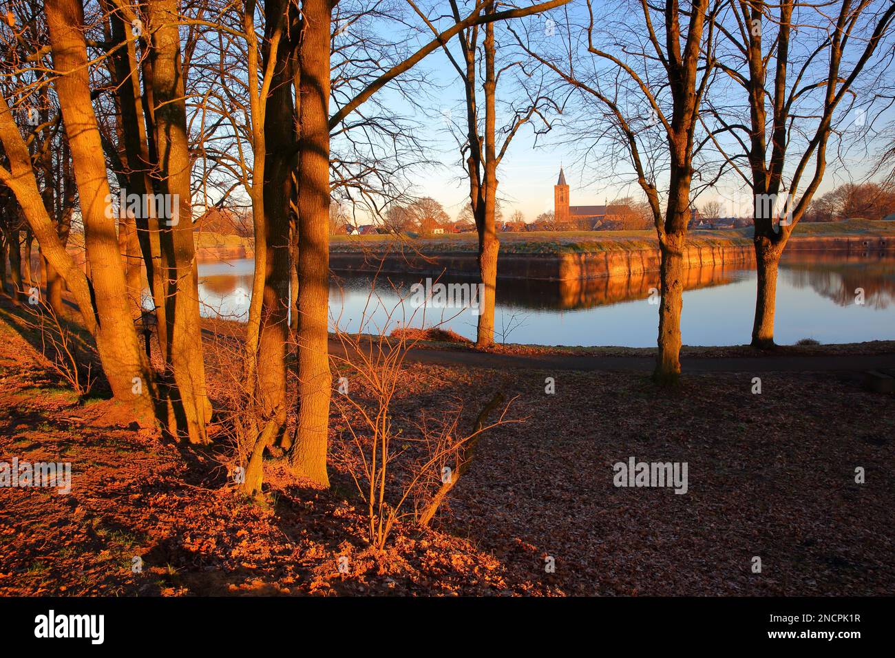 The fortifications and moats of the city of Naarden, Netherlands, with the Grote Kerk church in the background Stock Photo