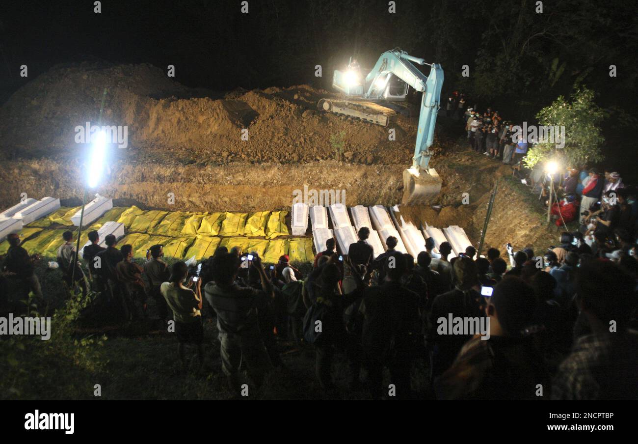 Villager gather at the grave of the victims of Mount Merapi eruption ...