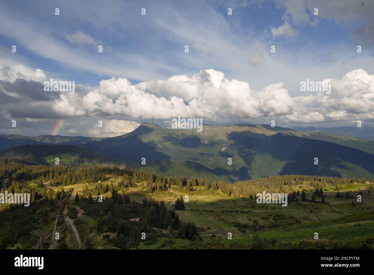 Fluffy clouds above valley landscape photo Stock Photo - Alamy