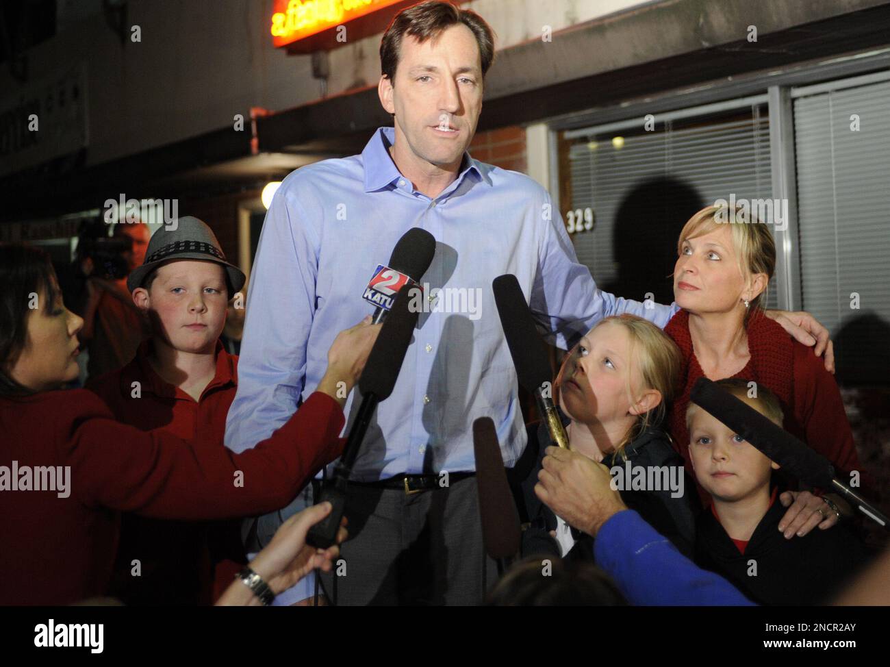 Oregon Republican gubernatorial candidate Chris Dudley, with his wife Chris  Love Dudley, right, and children from left, Charles Dudley, Emma Dudley and  Sam Dudley, concedes the victory to John Kitzhaber outside a