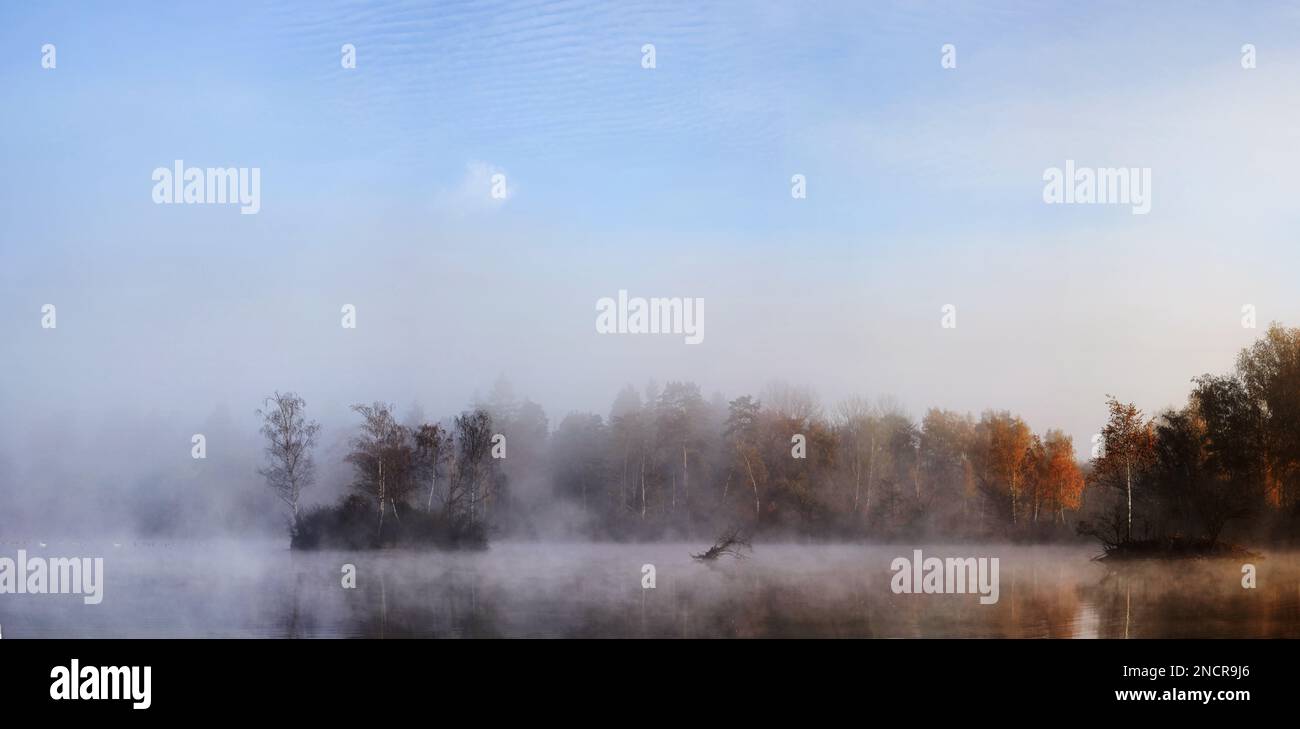 An aerial view of lake surrounded by autumn trees Stock Photo - Alamy