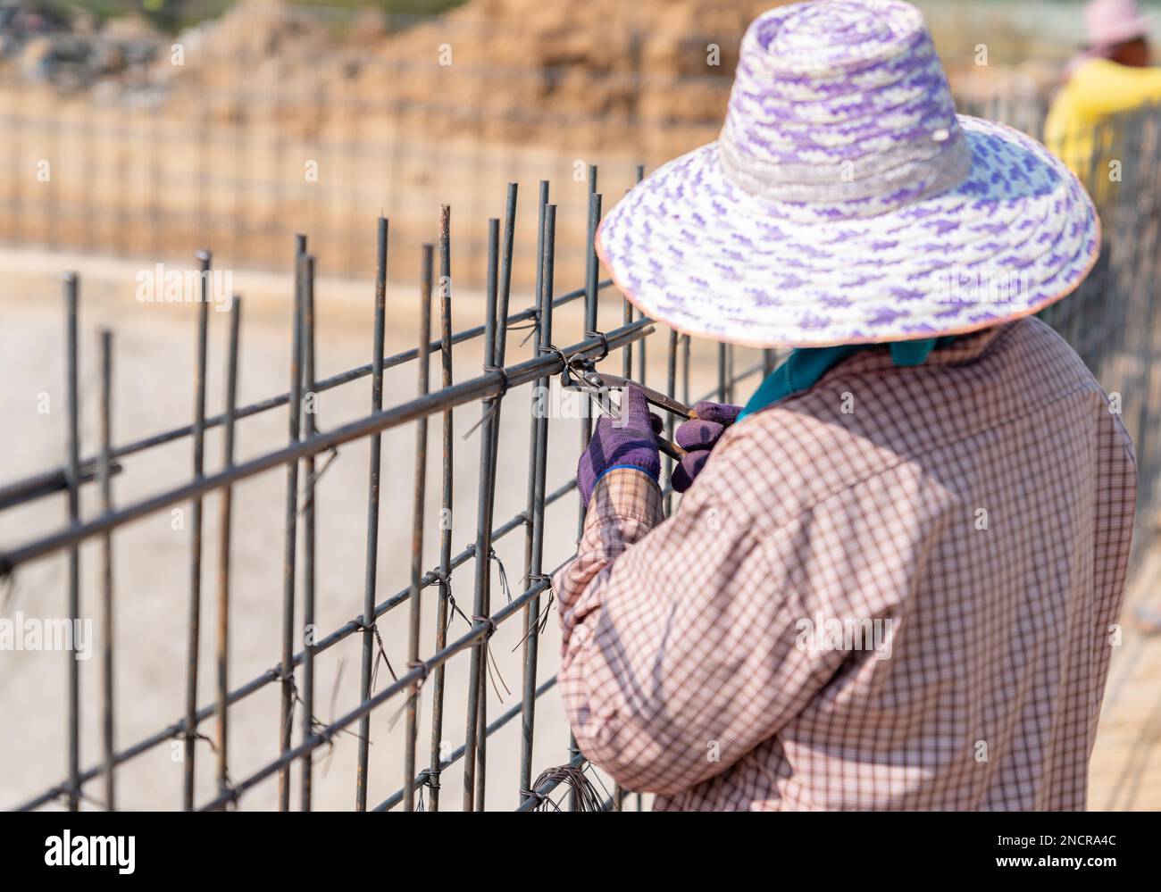 Worker bundle wire steel rod in construction site Stock Photo Alamy