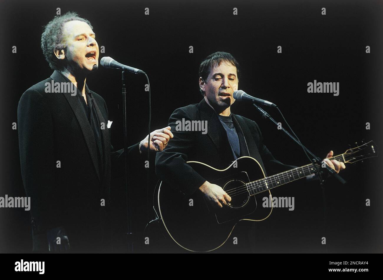Art Garfunkel, left, and Paul Simon perform together for the first