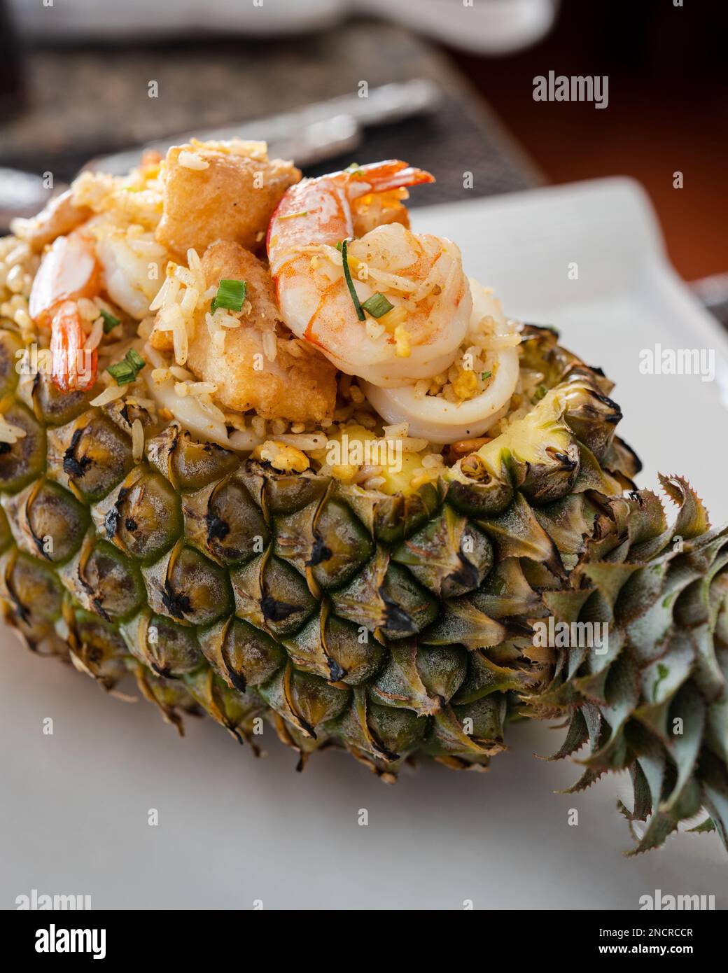 Shrimp and pineapple fried rice served in a hollowed out pineapple at Mama Tri's Kitchen near Kata Noi Beach in Phuket. Stock Photo