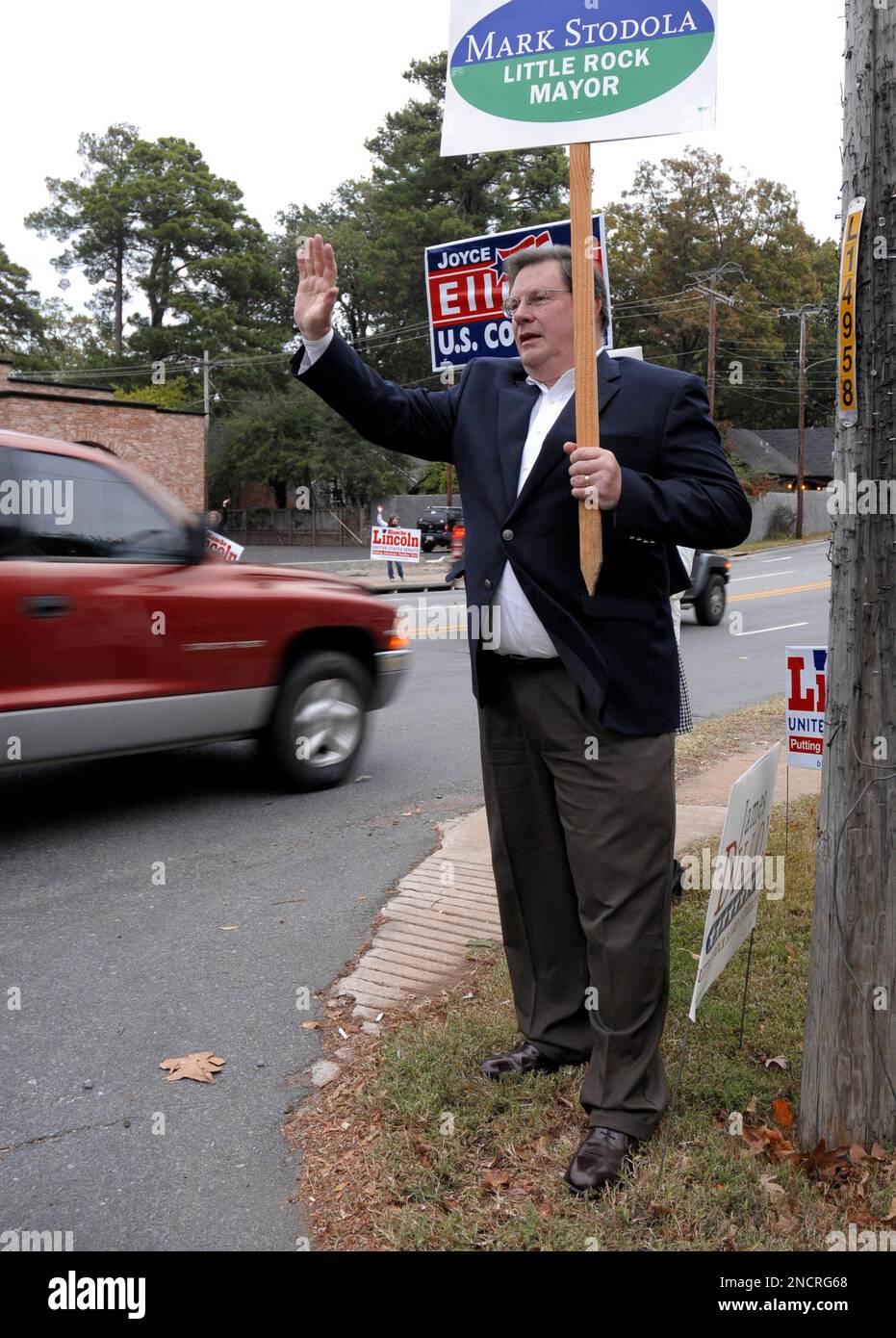 Incumbent Little Rock Mayor Mark Stodola waives to motorists on their ...