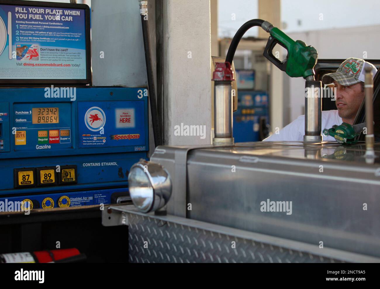 Domingo Benavides, a film production fueler fills his truck's gasoline