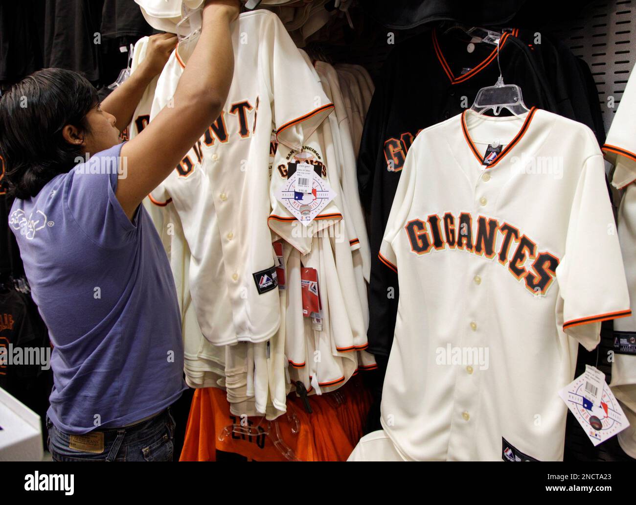 A fan looks for a jersey before Game 2 of baseball's World Series between  the San Francisco Giants and the Texas Rangers Thursday, Oct. 28, 2010, in  San Francisco. (AP Photo/Eric Risberg