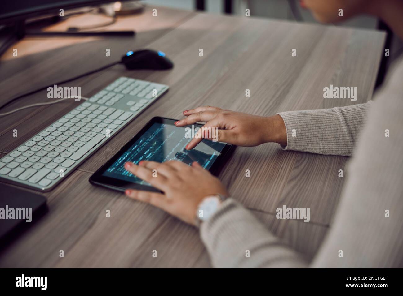 Tablet, hands and programmer screen for coding or programming on desk in office. Information technology, female developer and woman with digital Stock Photo