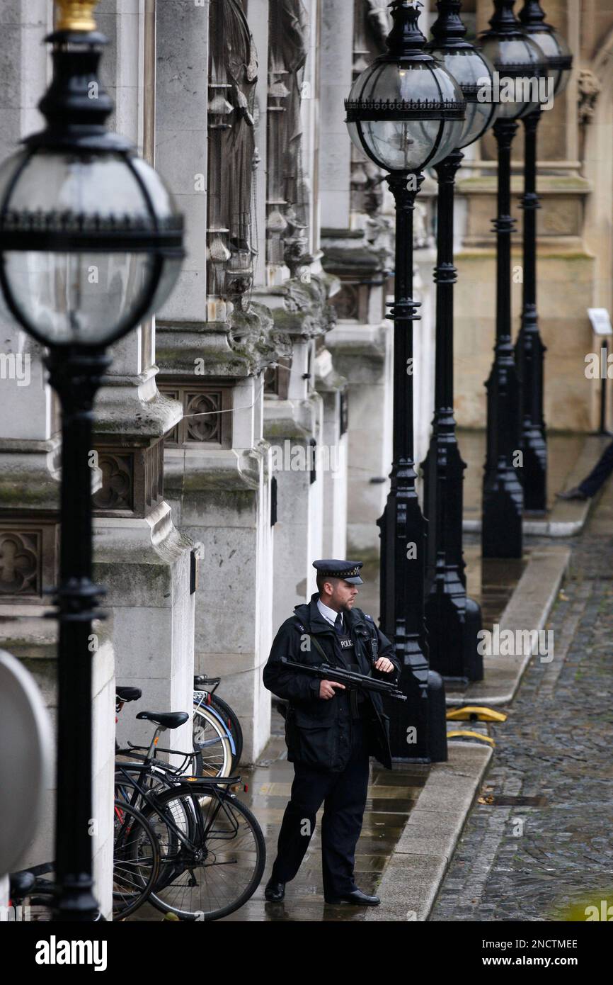A British armed police officers stands guard in the Houses of ...
