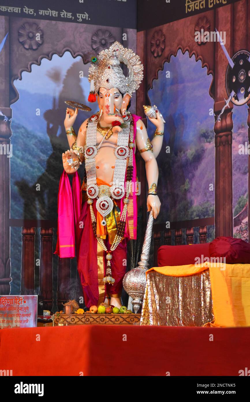 Standing Ganesha murti, Hindu Lord of Success, statue in a pandal during Ganesh Utsav festival at Pune, Maharashtra. Stock Photo