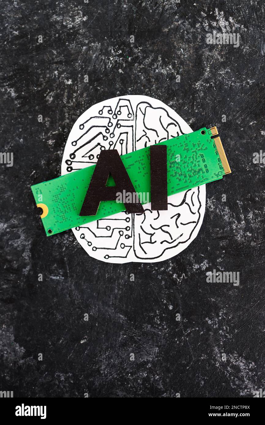 AI text on top of microchip and half human half robot brain,  the rise of Artificial Intelligence and deep learning technologies shaping the future Stock Photo