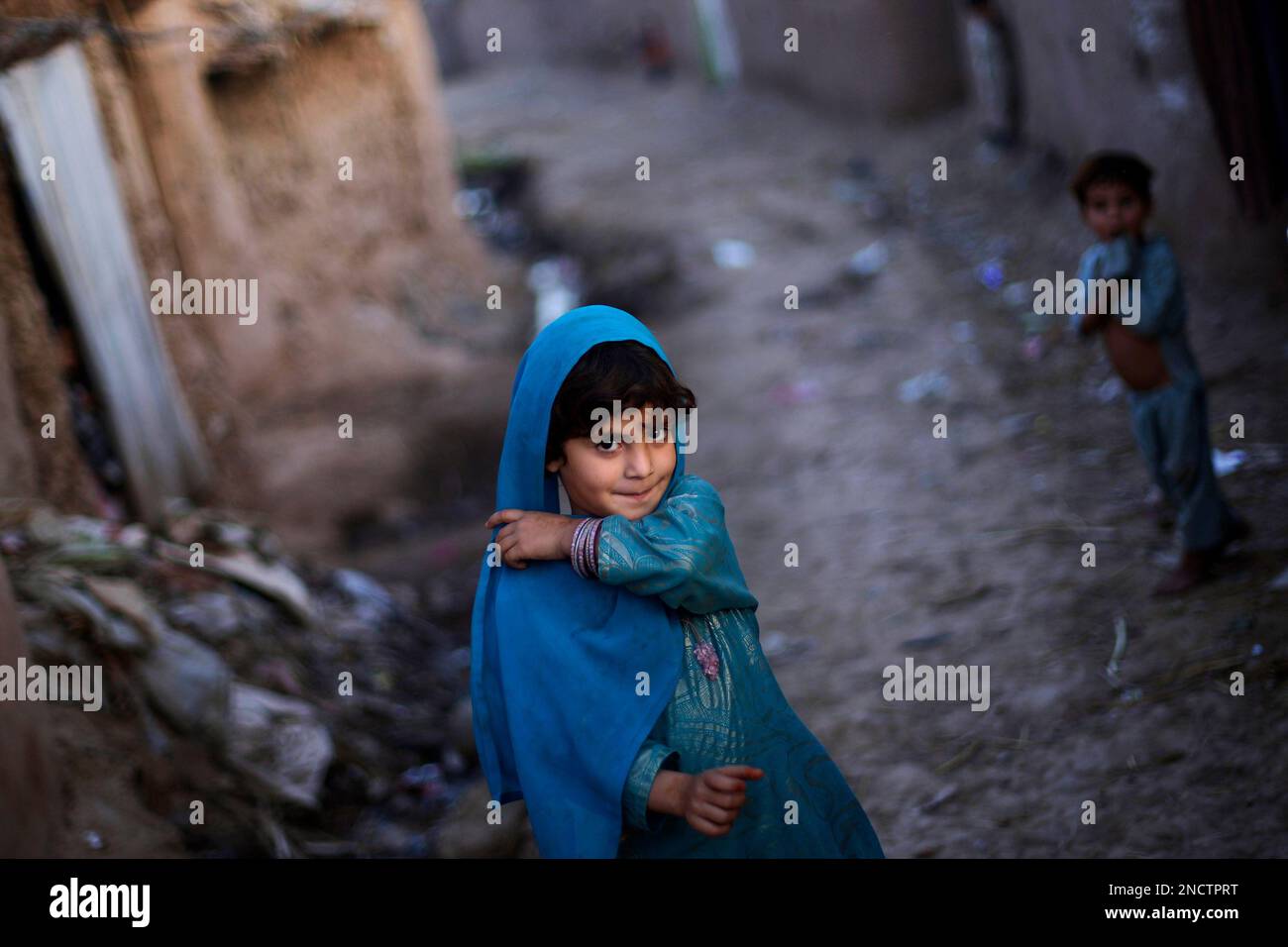 Pakistan Api Roshna Afghan refugee Roshna Shazad, 5, smiles while walking back to her home ...