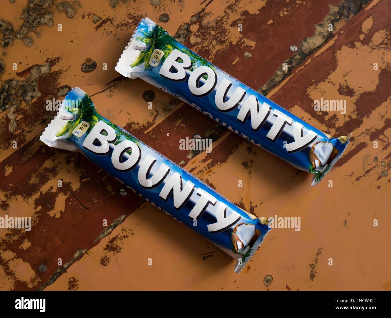 Сhocolate bar Bounty on a brown background. Stock Photo