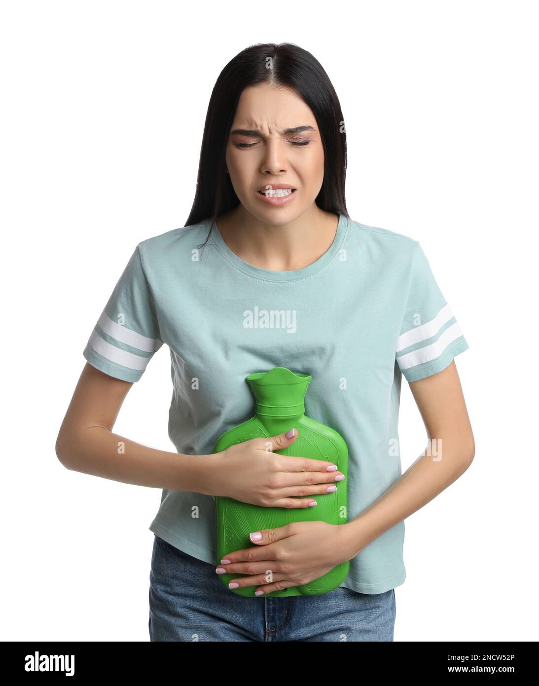 Woman using hot water bottle to relieve abdominal pain on white